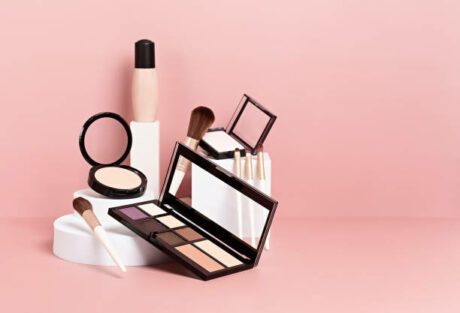 Make up products prsented on white podiums on pink pastel background. Mockup for branding and packaging presentation